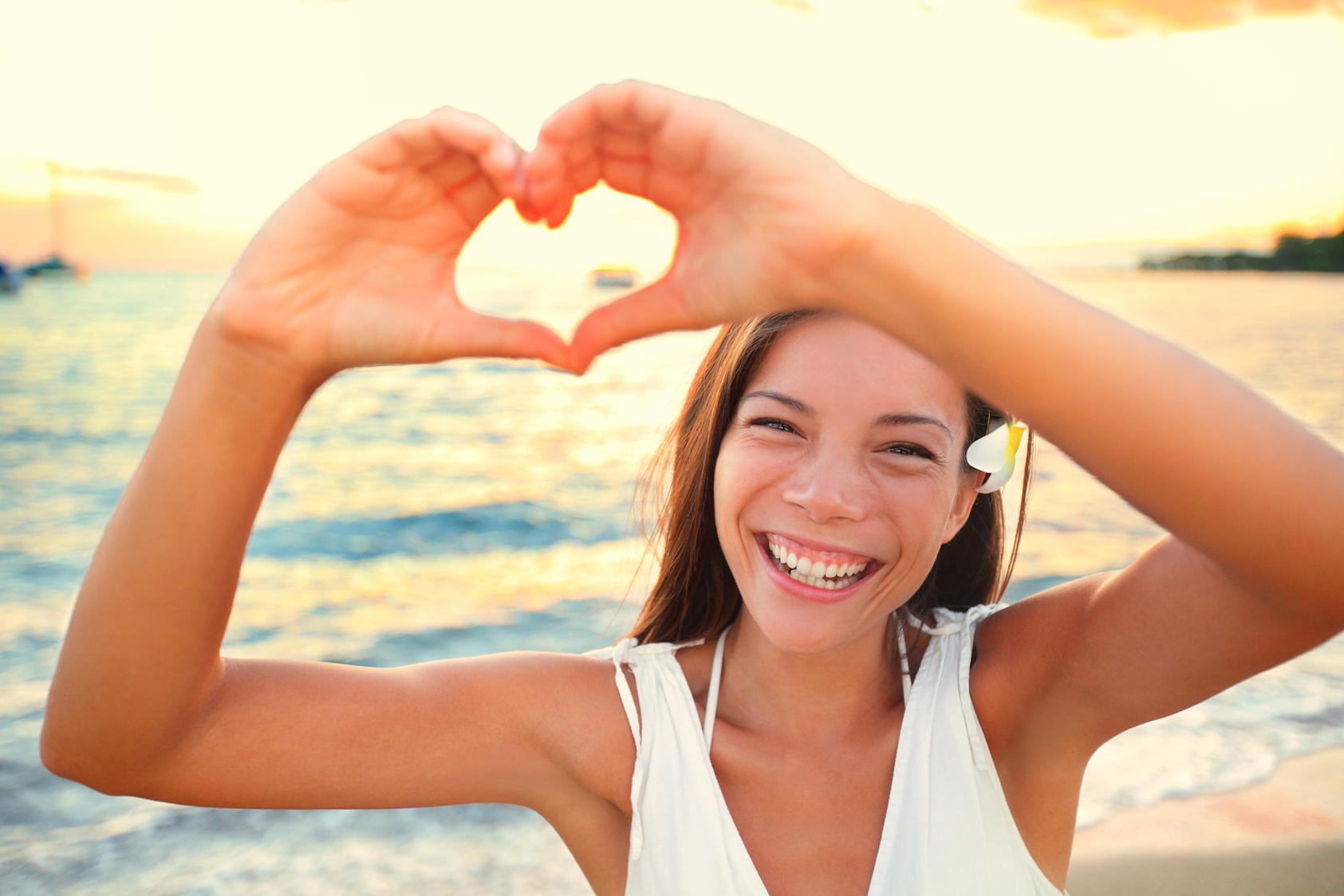 Woman Showing Heart on Beach