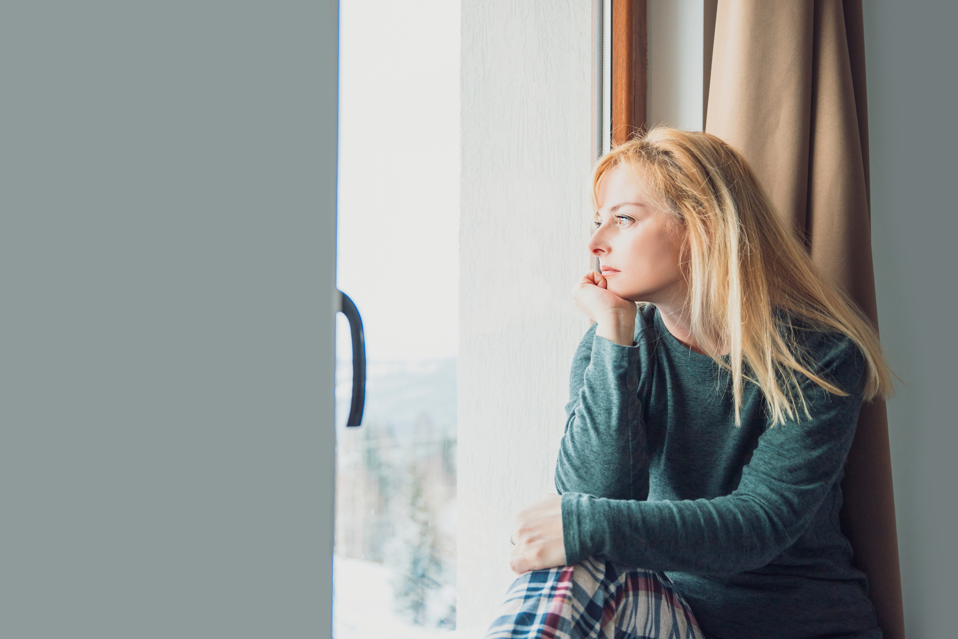 Lonely Woman looking out window